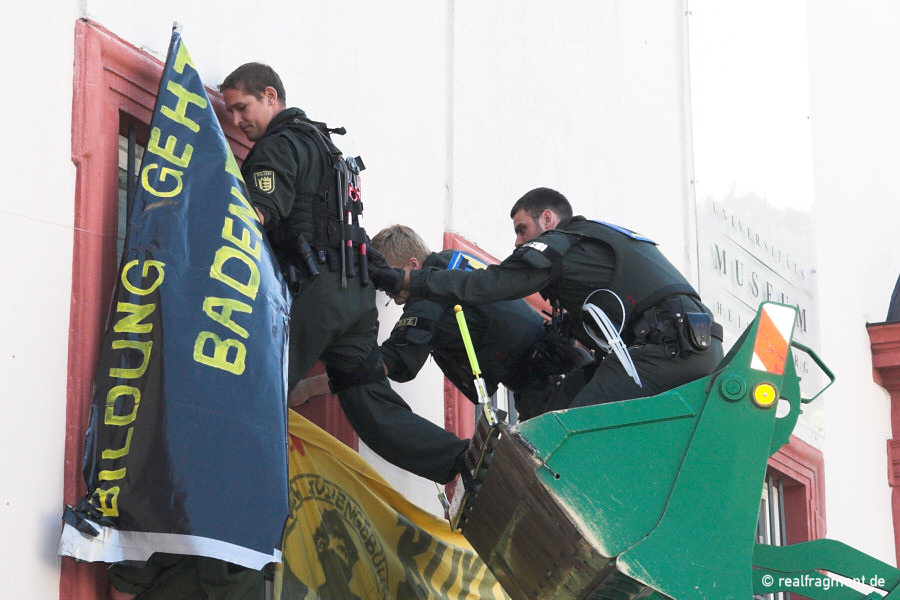 Polizisten entfernen Transparente vom Rektoratsgebäude