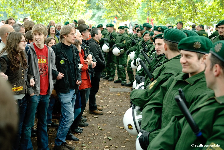 Protesters and police standing face to face