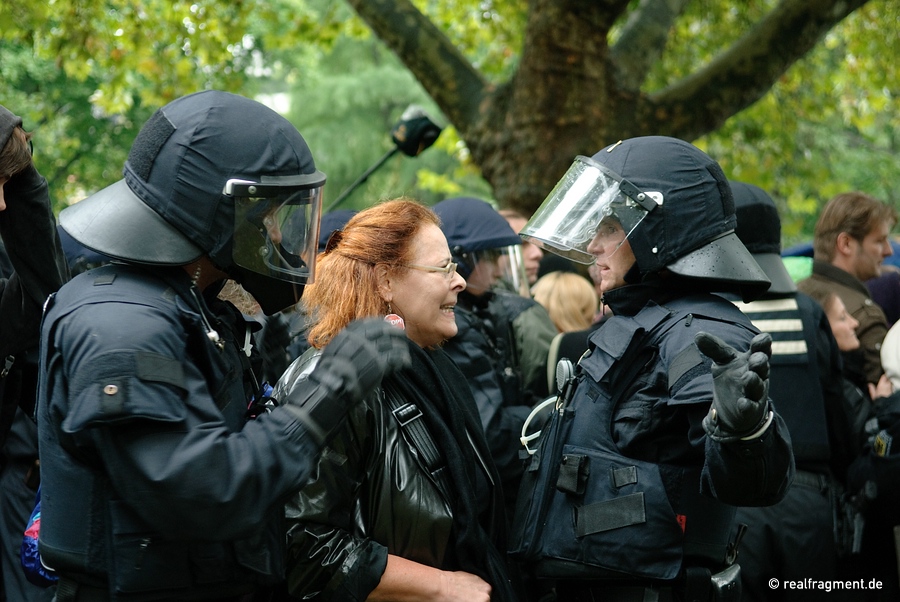 A police man is justifying himself against a disgusted protester